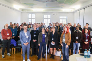 Personengruppe vor einer hellen Wand, vermutlich Teilnehmer eines Netzwerktreffens.